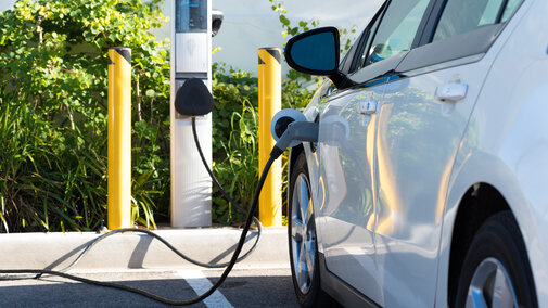 Electric car plugged in at charger